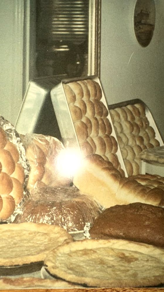 Rolls, breads and pies spread across a table at a family gathering more than fifty years ago
